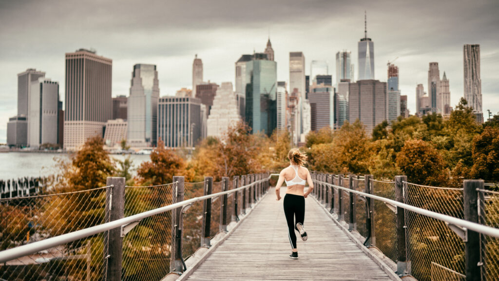 Woman Running in Brooklyn with views of Manhattan in the background
